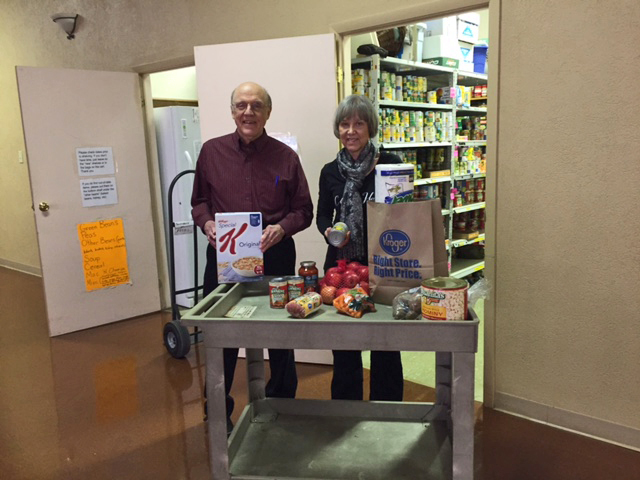 Marlene and Frank Morris of Blue Ash volunteering together at NEEDS, putting donated food into the pantry.