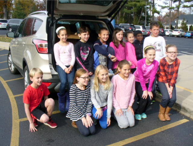 Picture of children in front of an opened van trunk